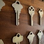 House keys on wooden surface, side angle view.