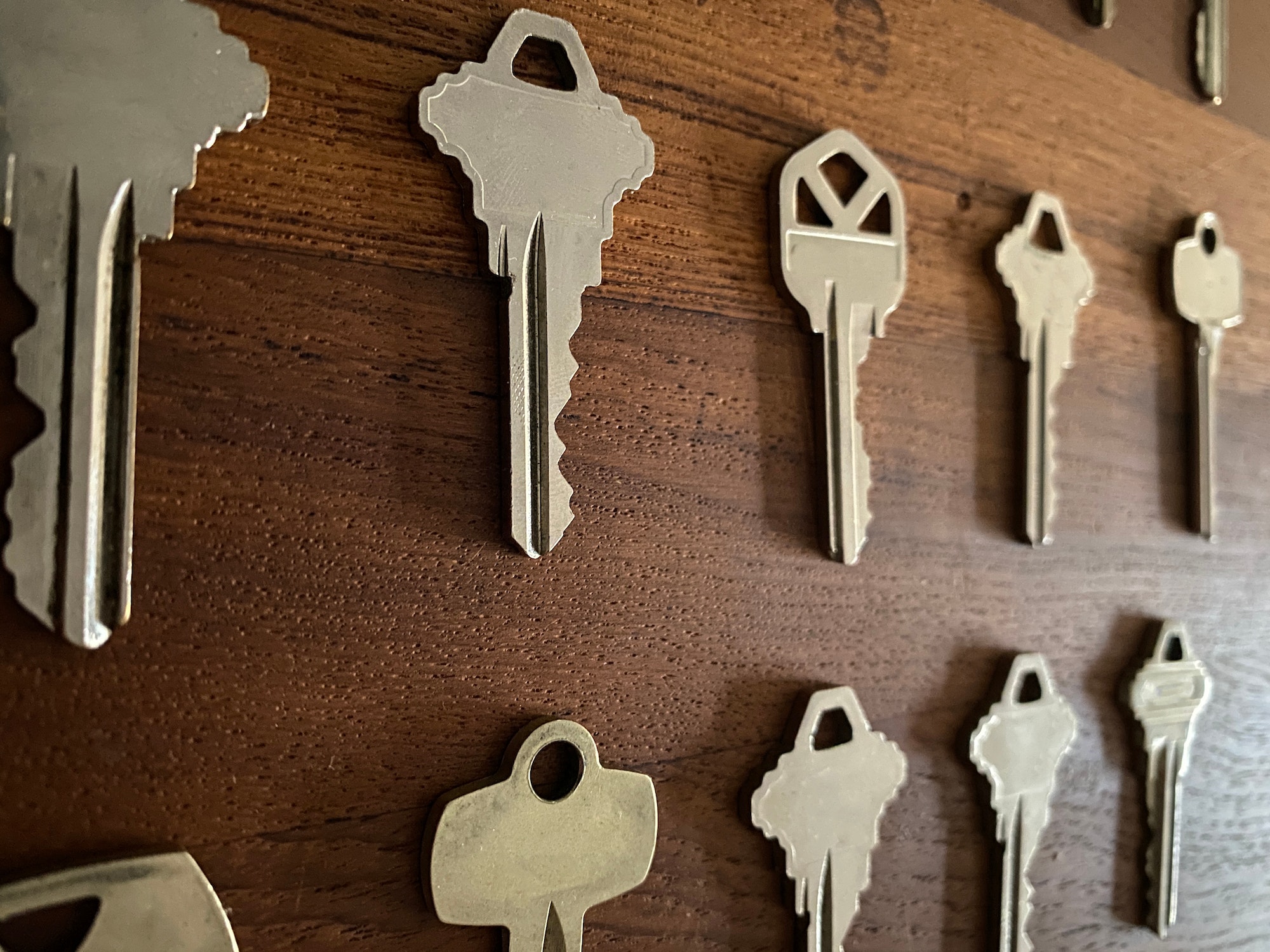 House keys on wooden surface, side angle view.