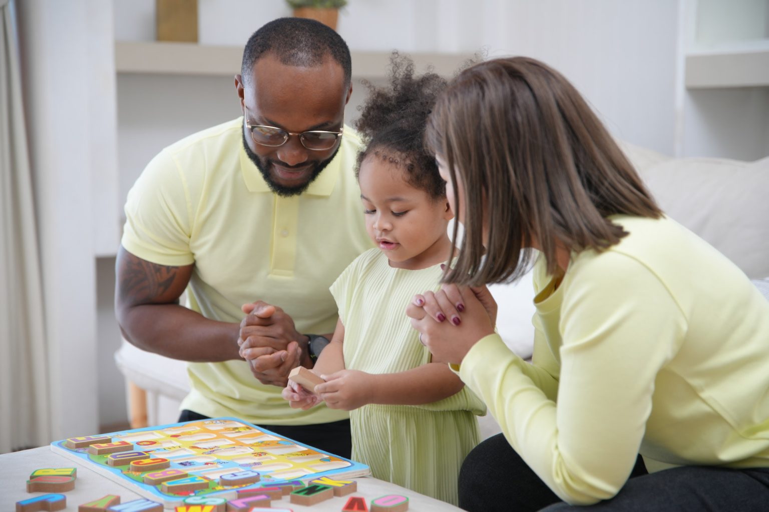 Mixed race family, Little girl with special needs enjoy spending time with family.