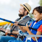 Son feeling excited while fishing for the first time with daddy