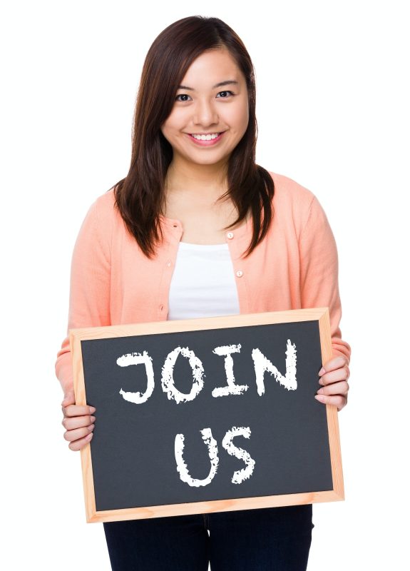 Asian woman with black board showing phrase join us